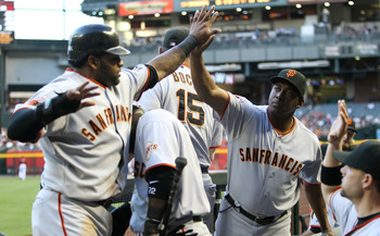 PHOENIX, AZ - JUNE 15:  Batting coach Hensley Meulens of the San Francisco Giants high fives Pablo Sandoval #48 after he scored a first inning run against the Arizona Diamondbacks during the Major League Baseball game at Chase Field on June 15, 2011 in Ph