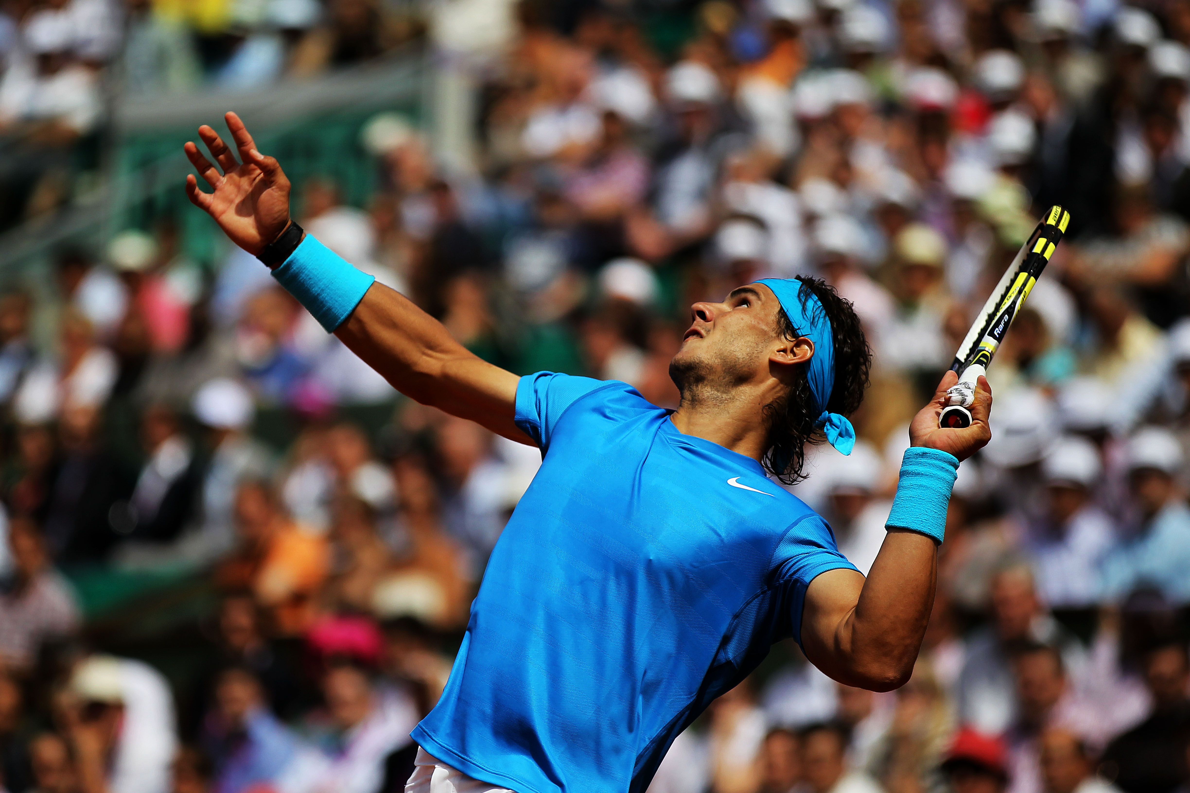 PARIS, FRANCE - MAY 24:  Rafael Nadal of Spain serves during the men's singles round one match between Rafael Nadal of Spain and John Isner of USA on day three of the French Open at Roland Garros on May 24, 2011 in Paris, France.  (Photo by Matthew Stockm