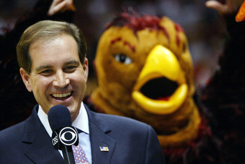 EAST RUTHERFORD, NJ - MARCH 27:  CBS analyst Jim Nantz shows a smile as the St. Joseph's Hawks mascot flaps his arms in the background before the start of the fourth round regional game of the NCAA Division I Men's Basketball Tournament against Oklahoma S