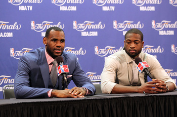 MIAMI, FL - JUNE 12:  (L-R) LeBron James #6 and Dwyane Wade #3 of the Miami Heat answers questions from the media at a post game news conference after the Dallas Mavericks won 105-95 in Game Six of the 2011 NBA Finals at American Airlines Arena on June 12