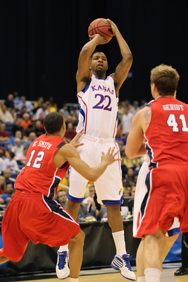 SAN ANTONIO, TX - MARCH 25:  Marcus Morris #22 of the Kansas Jayhawks shoots over Kevin Smith #12 and Dan Geriot #41 of the Richmond Spiders during the southwest regional of the 2011 NCAA men's basketball tournament at the Alamodome on March 25, 2011 in S