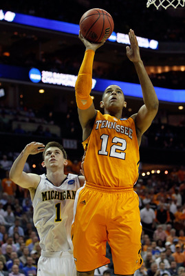 CHARLOTTE, NC - MARCH 18:  Tobias Harris #12 of the Tennessee Volunteers lays the ball up in front of Stu Douglass #1 of the Michigan Wolverines in the first half during the second round of the 2011 NCAA men's basketball tournament at Time Warner Cable Ar
