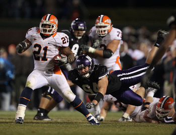 CHICAGO - NOVEMBER 20: Jason Ford #21 of the Illinois Fighting Illini breaks away from Vince Browne #94 of the Northwestern Wildcats during a game played at Wrigley Field on November 20, 2010 in Chicago, Illinois. Illinois defeated Northwestern 48-27. (Ph