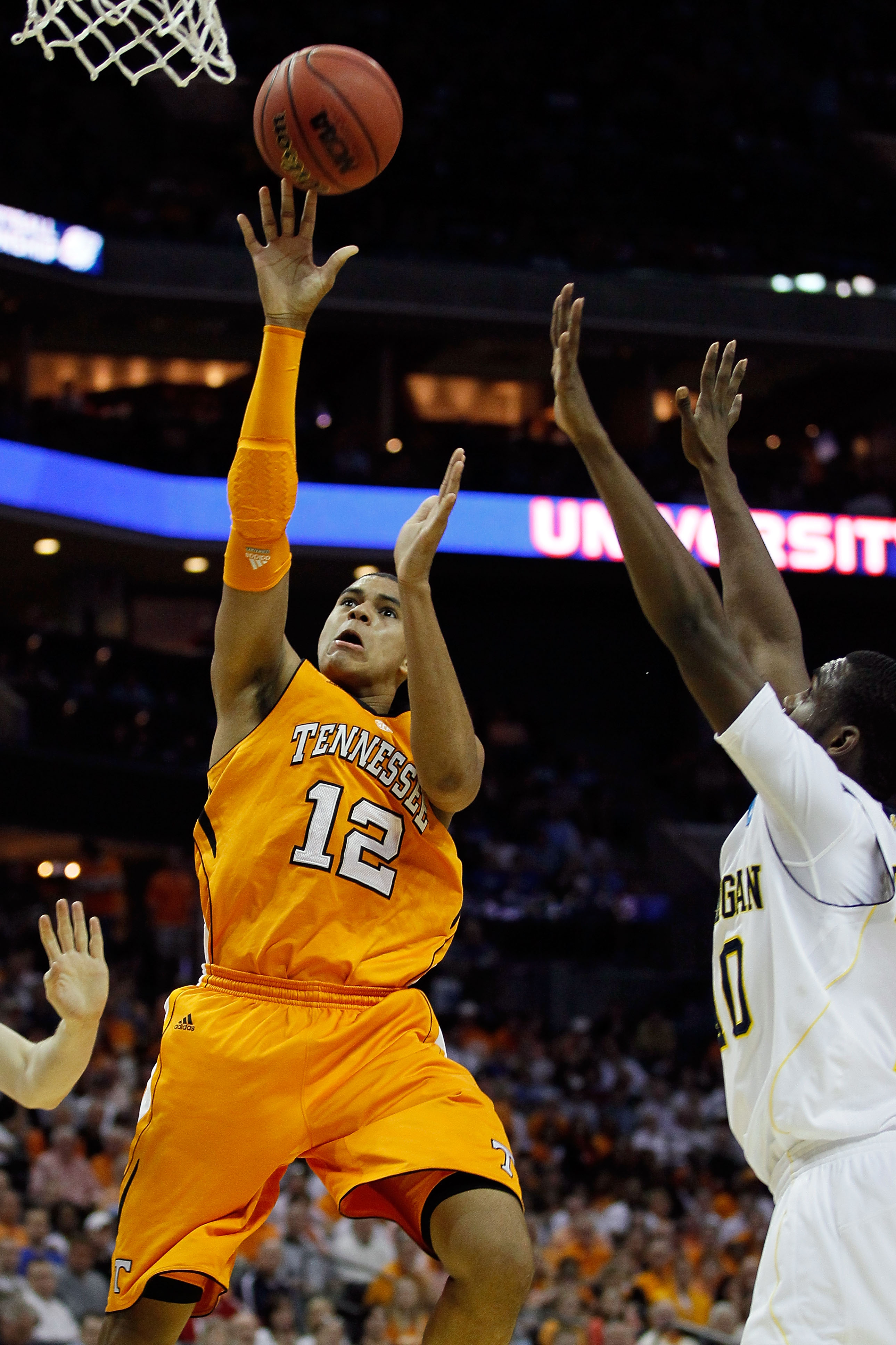 CHARLOTTE, NC - MARCH 18:  Tobias Harris #12 of the Tennessee Volunteers shoots over Tim Hardaway Jr. #10 of the Michigan Wolverines in the first half during the second round of the 2011 NCAA men's basketball tournament at Time Warner Cable Arena on March