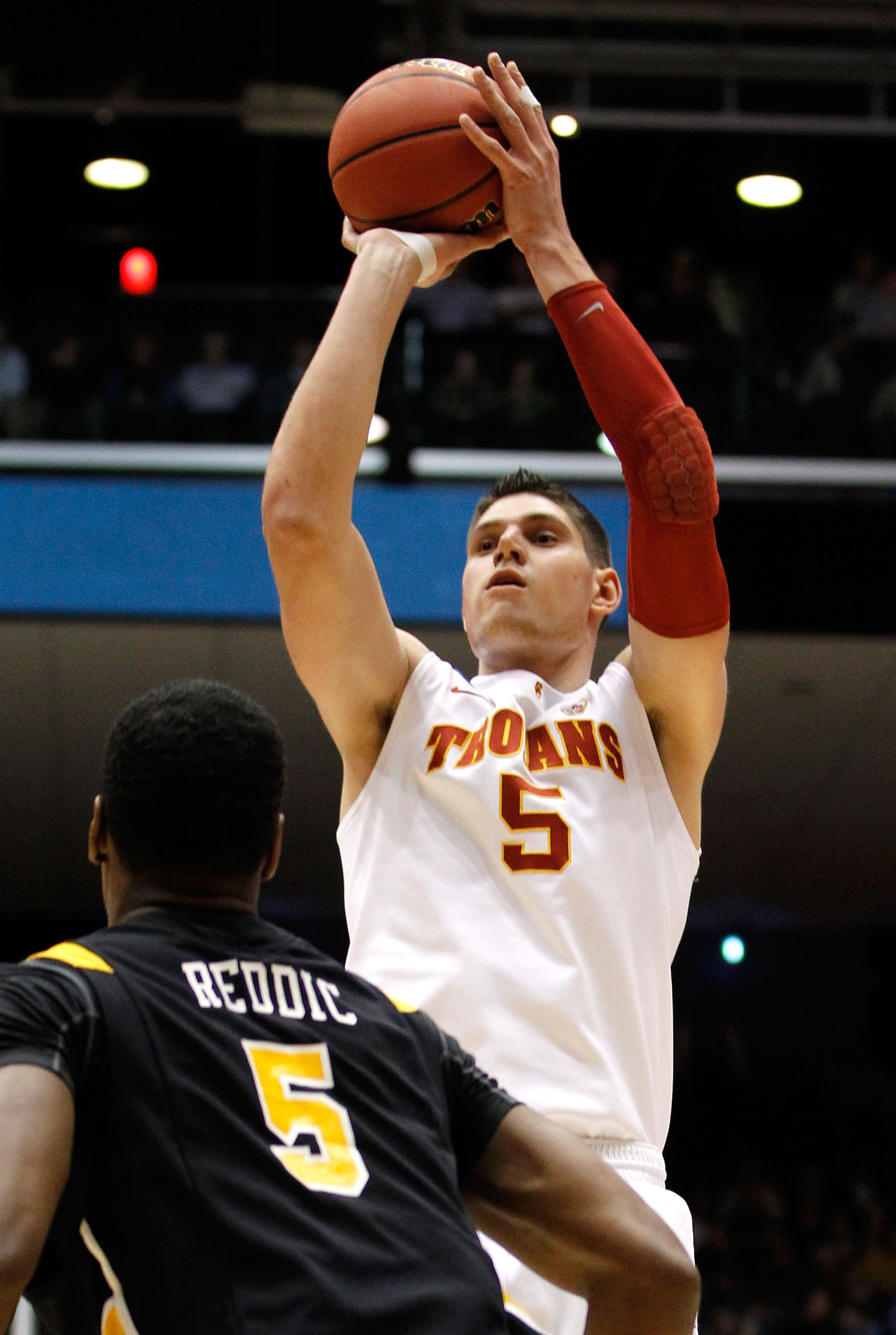 DAYTON, OH - MARCH 16: Nikola Vucevic #5 of the USC Trojans shoots over Juvonte Reddic #5 of the Virginia Commonwealth Rams during the first round of the 2011 NCAA men's basketball tournament at UD Arena on March 16, 2011 in Dayton, Ohio.  (Photo by Grego