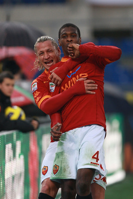 ROME, ITALY - DECEMBER 12:  Juan (R) with his teammate Philippe Mexes of AS Roma celebrates after scoring the opening goal during the Serie A match between AS Roma and AS Bari at Stadio Olimpico on December 12, 2010 in Rome, Italy.  (Photo by Paolo Bruno/