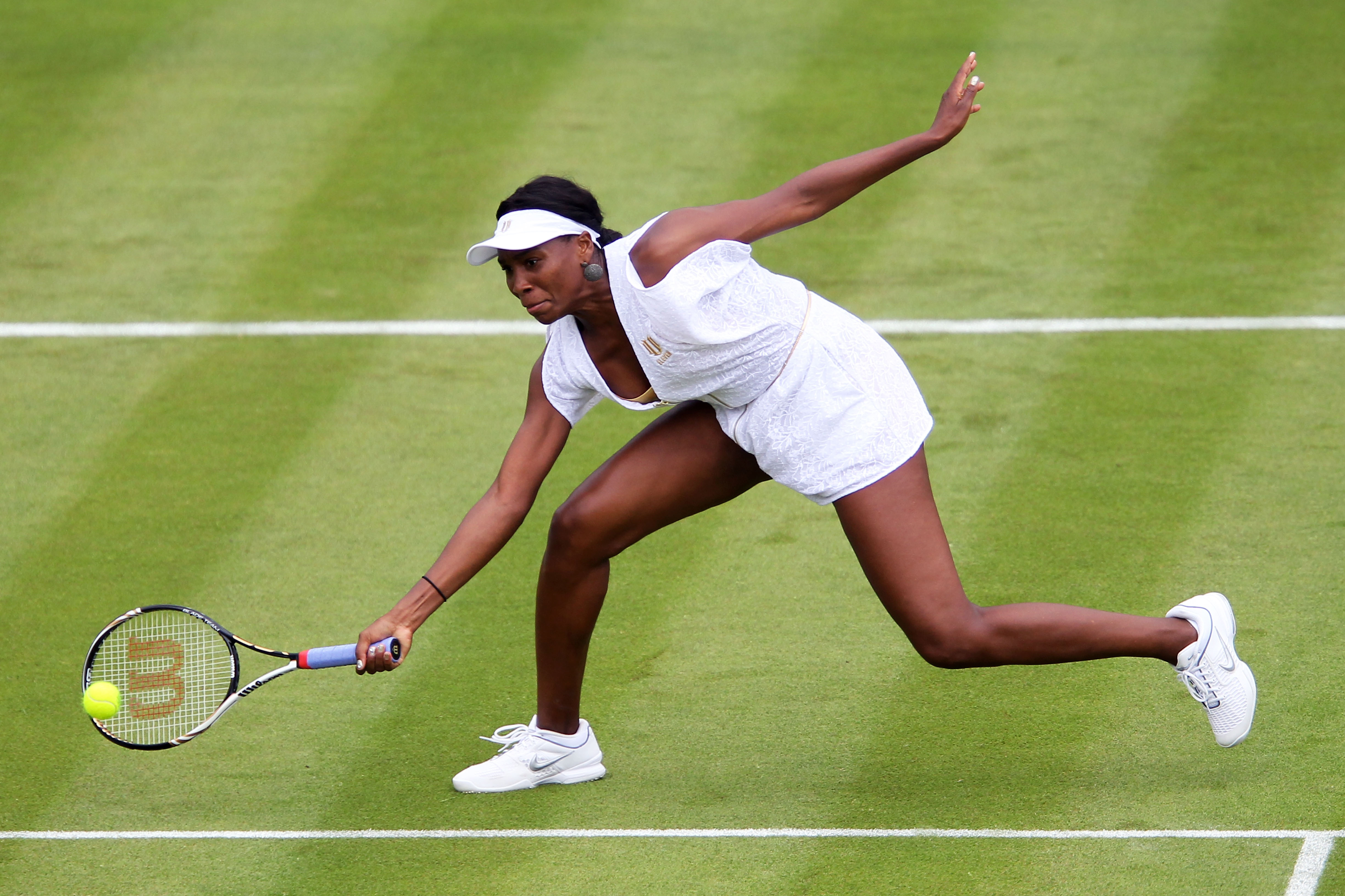 LONDON, ENGLAND - JUNE 20:  Venus Williams of the United States returns a shot during her first round match Akgul Amanmuradova of Uzbekistan on Day One of the Wimbledon Lawn Tennis Championships at the All England Lawn Tennis and Croquet Club on June 20,