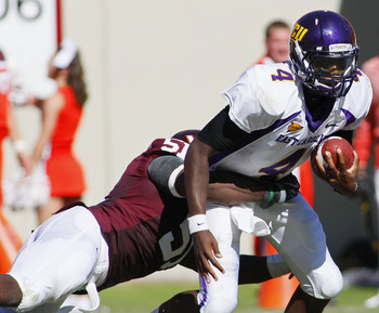 BLACKSBURG, VA - SEPTEMBER 18: Quarterback Dominique Davis #4 of the East Carolina Pirates is sacked by linebacker Bruce Taylor #51 of the Virginia Tech Hokies at Lane Stadium on September 18, 2010 in Blacksburg, Virginia. (Photo by Geoff Burke/Getty Ima