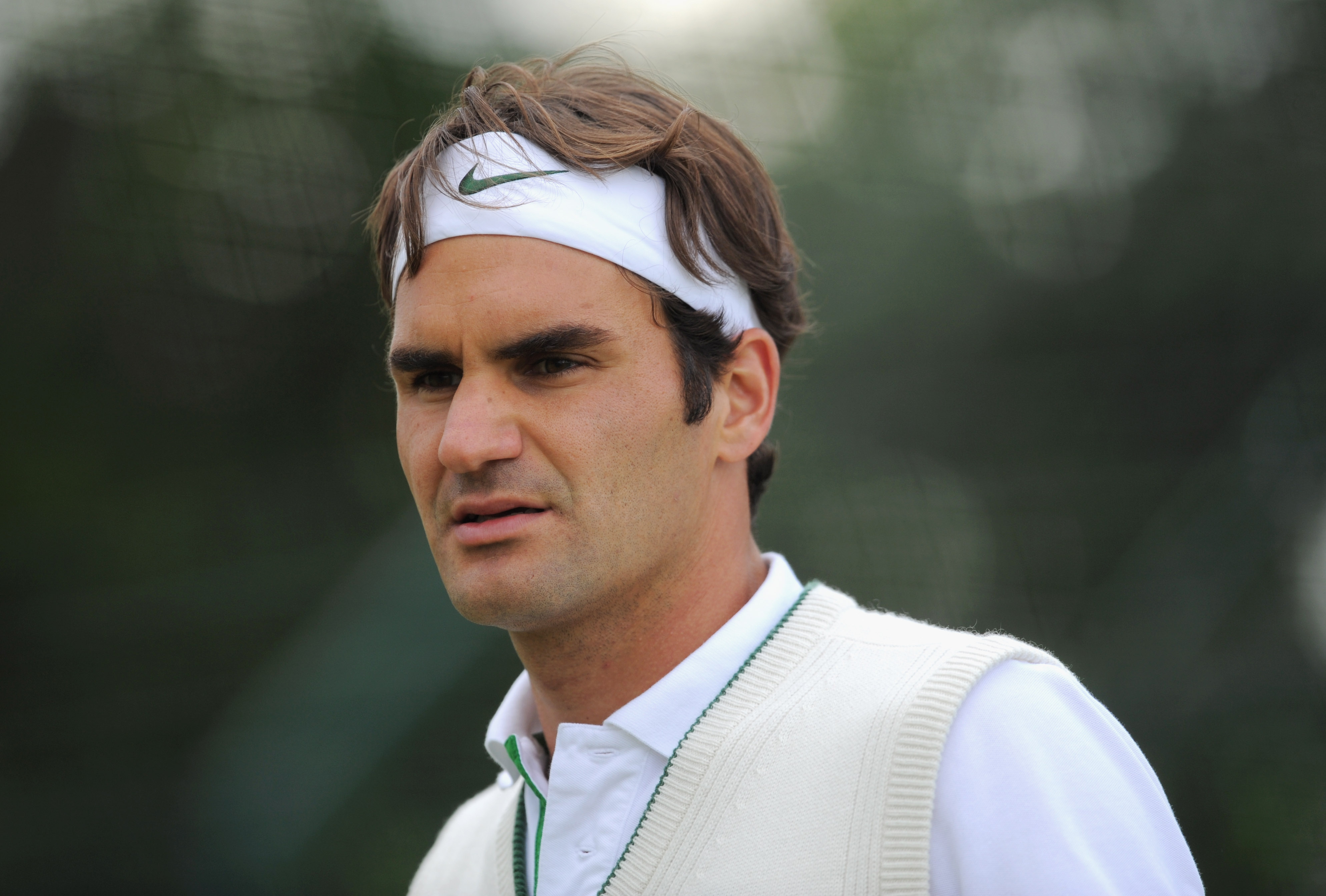 WIMBLEDON, ENGLAND - JUNE 19:  Roger Federer of Switzerland looks on during a training session ahead of the Wimbledon Lawn Tennis Championships on June 19, 2011 in Wimbledon, England.  (Photo by Michael Regan/Getty Images)