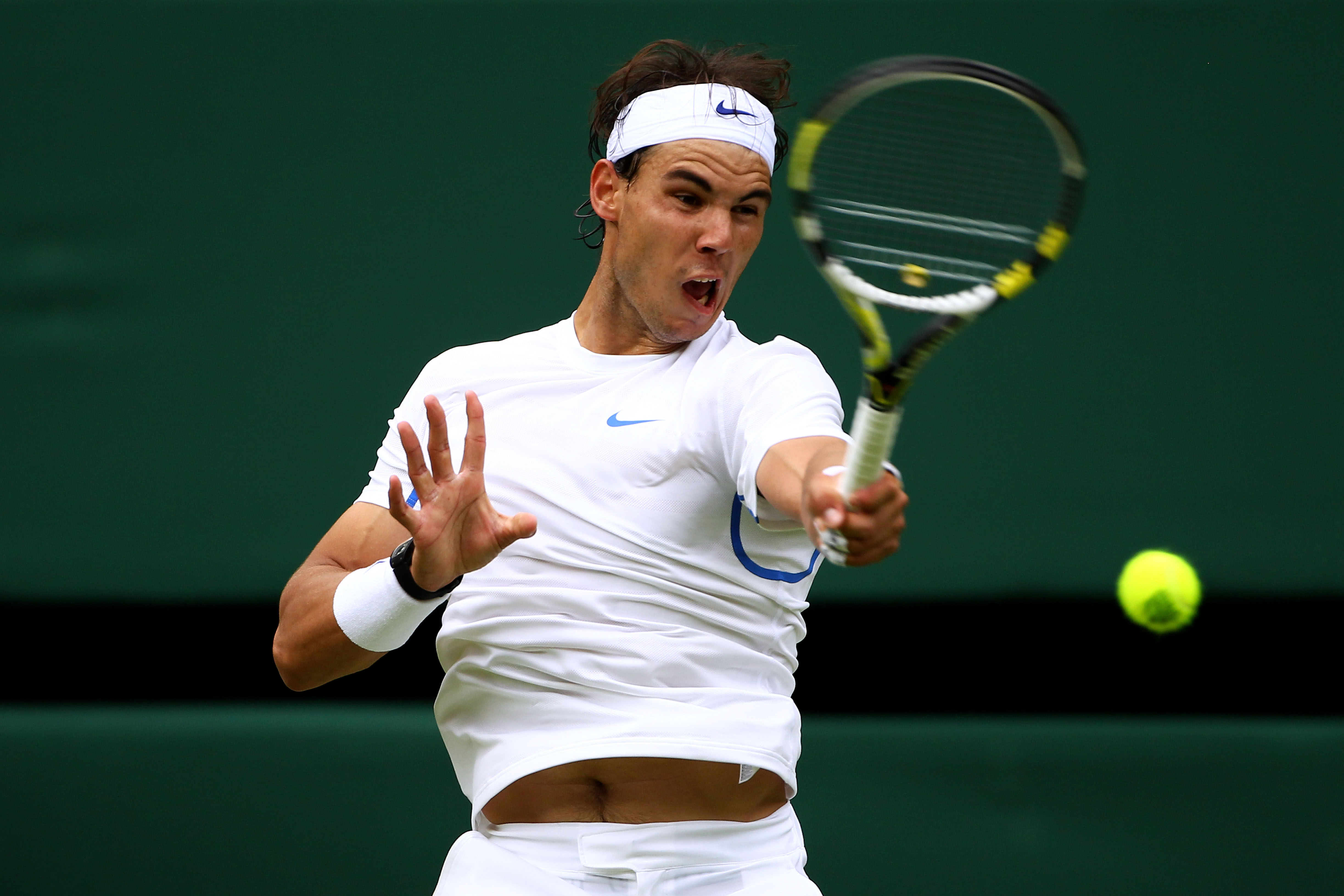 LONDON, ENGLAND - JUNE 20:  Rafael Nadal of Spain returns a shot during his first round match against Michael Russell of the United States on Day One of the Wimbledon Lawn Tennis Championships at the All England Lawn Tennis and Croquet Club on June 20, 20