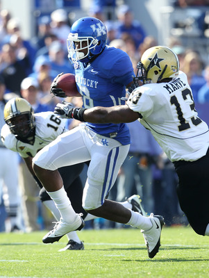 LEXINGTON, KY - NOVEMBER 13: Chris Matthews #8 of the Kentucky Wildcats runs with the ball while defended by Chris Marve #13 of the Vanderbilt Commodores at Commonwealth Stadium on November 13, 2010 in Lexington, Kentucky. (Photo by Andy Lyons/Getty Ima