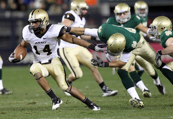 NEW YORK - NOVEMBER 20: Josh Jackson #14 of the Army Black Knights is tackled on a kickoff return by the Notre Dame Fighting Irish at Yankee Stadium on November 20, 2010 in the Bronx borough of New York City. (Photo by Nick Laham/Getty Images)