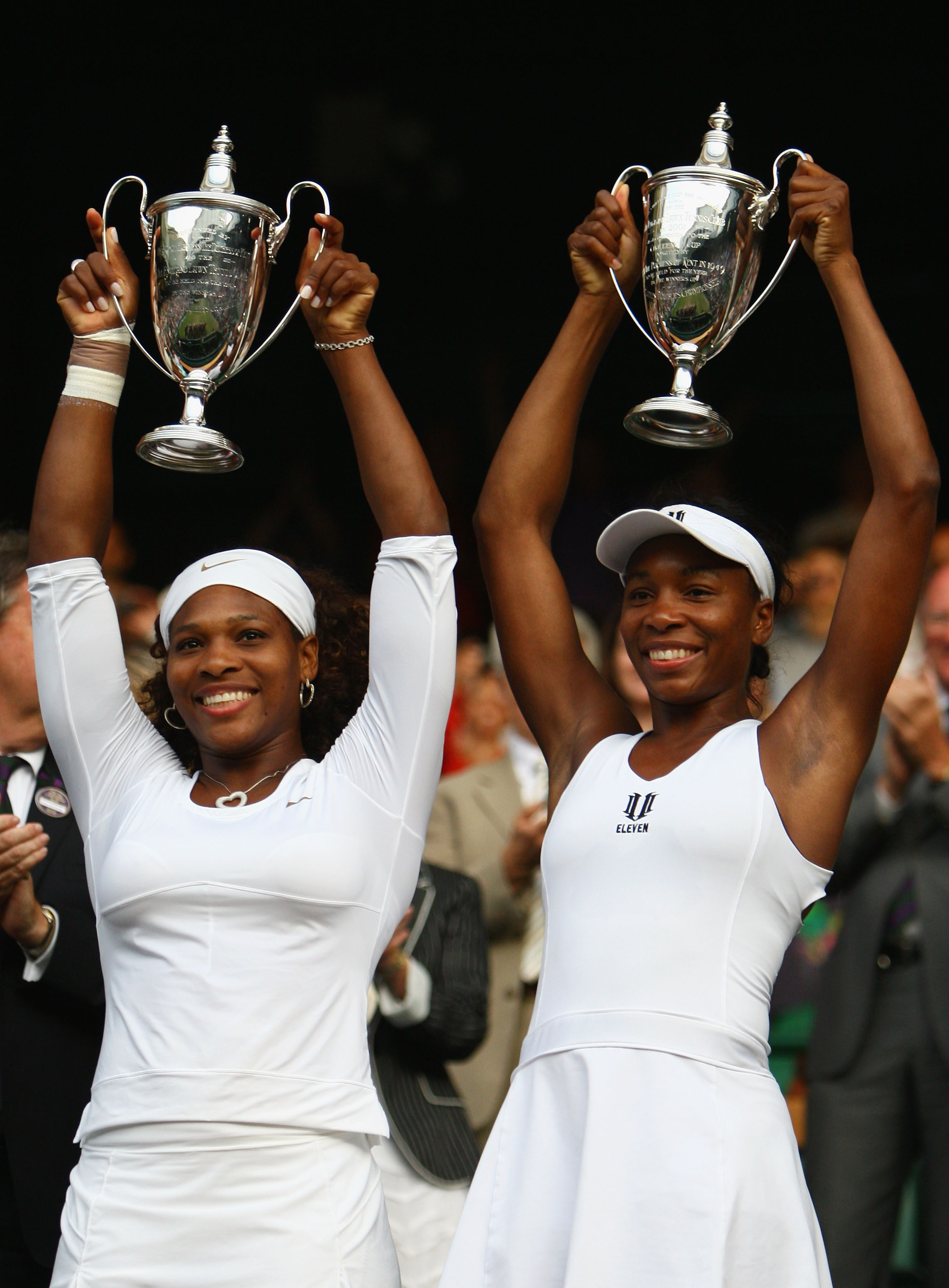 WIMBLEDON, ENGLAND - JULY 04:  Venus Williams of USA (L) and Serena Williams of USA celebrate victory with their trophies after the women's doubles final match against Samantha Stosur of Australia and Rennae Stubbs of Australia on Day Twelve of the Wimble