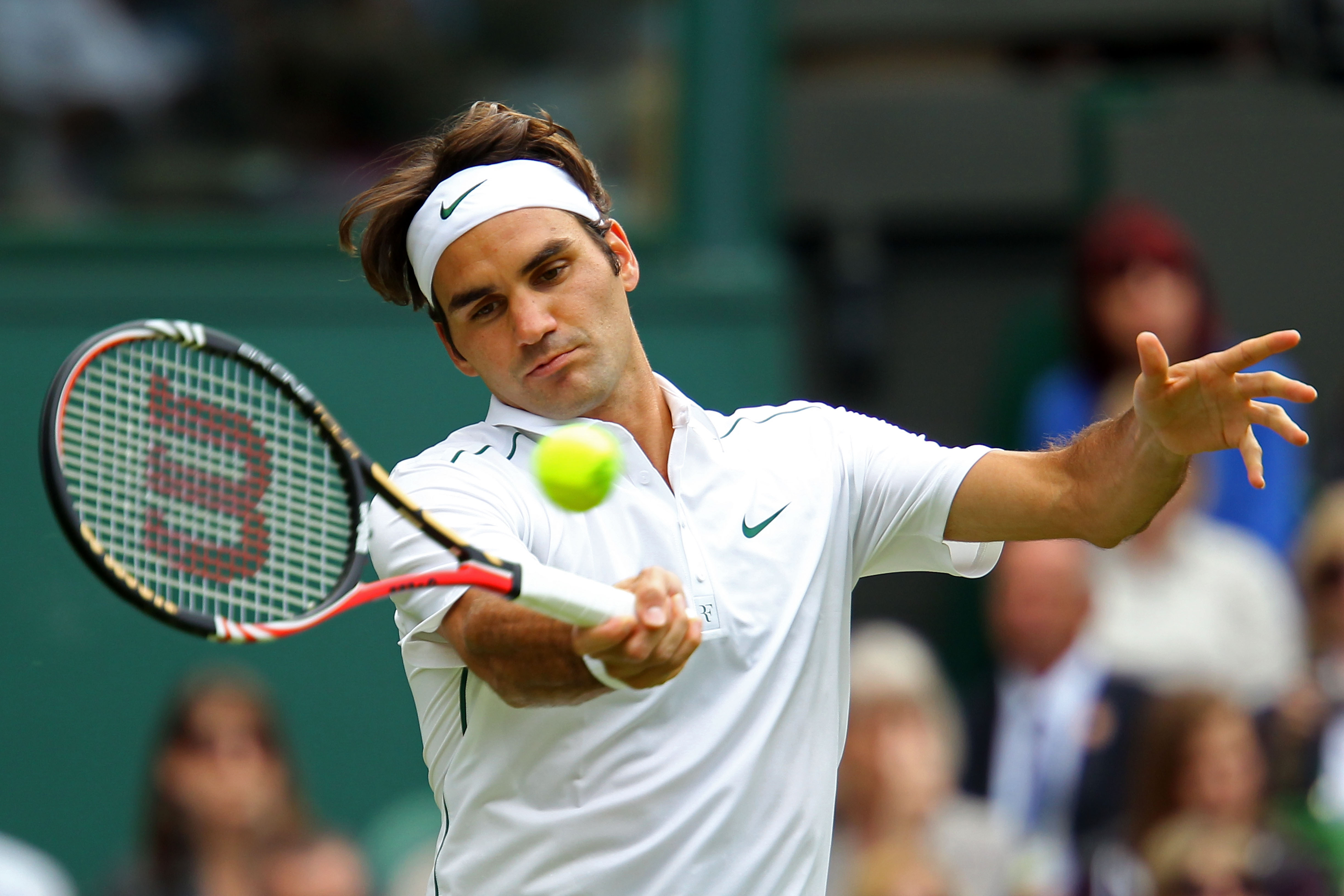 LONDON, ENGLAND - JUNE 21:  Roger Federer of Switzerland returns a shot during his first round match against Mikhail Kukushkin of Kazakhstan on Day Two of the Wimbledon Lawn Tennis Championships at the All England Lawn Tennis and Croquet Club on June 21,