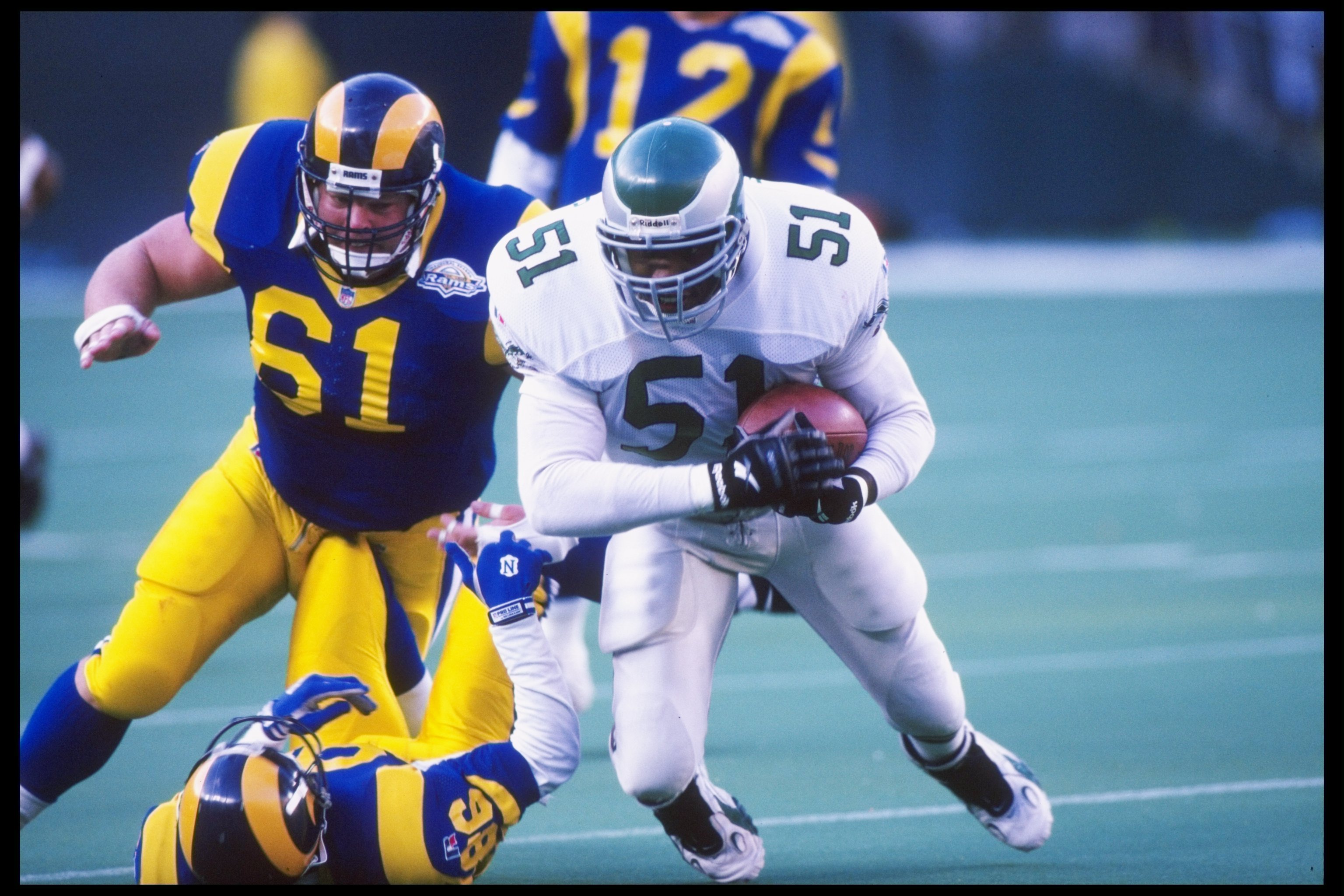 29 Oct 1995: Linebacker William Thomas of the Philadelphia Eagles tries to break away from guard Bern Brostek and tight end Jessie Hester of the St. Louis Rams during a game at Veterans Stadium in Philadelphia, Pennsylvania. The Eagles won the game 20-9.