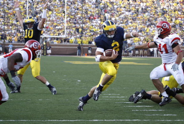 ANN ARBOR, MI - AUGUST 30: Sam McGuffie #2 of the Michigan Wolverines runs for a fourth quarter touchdown past Koa Misi #41 with Steven Threet #10 celebrating in the background on August 30, 2008 at Michigan Stadium in Ann Arbor, Michigan. Utah won the g