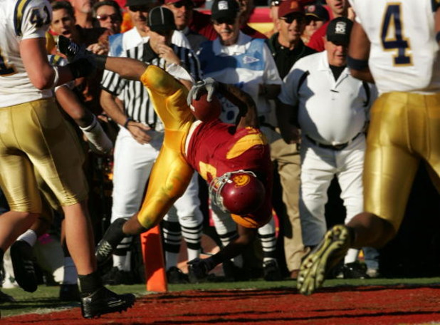 LOS ANGELES, CA - DECEMBER 03: Reggie Bush #5 of the USC Trojans dives in the endzone for a touchdown against the UCLA Bruins December 3, 2005 at the Los Angeles Memorial Coliseum in Los Angeles, California. USC won 66-19. (Photo by Stephen Dunn/Getty Im