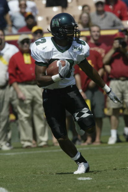LOS ANGELES - SEPTEMBER 13: Ross Dickerson #82 of the University of Hawaii Warriors runs with the ball against the University of Southern California Trojans at the Los Angeles Coliseum on September 13, 2003 in Los Angeles, California. USC defeated Hawai