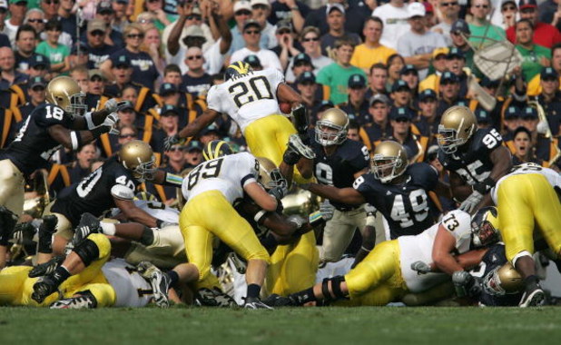 SOUTH BEND, IN - SEPTEMBER 16:  Mike Hart #20 of the Michigan Wolverines dives over the pile for a touchdown against the Notre Dame Fighting Irish September 16, 2006 at Notre Dame Stadium in South Bend, Indiana.  (Photo by Jonathan Daniel/Getty Images)