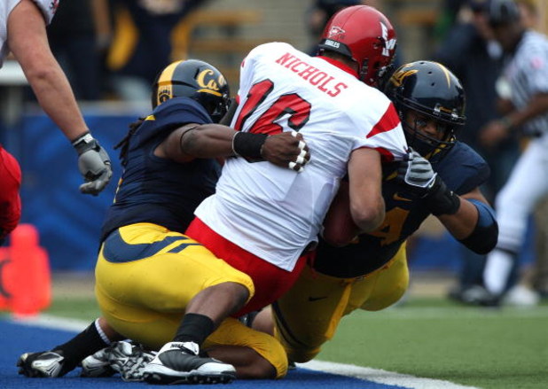 BERKELEY, CA - SEPTEMBER 12:  Eddie Young #9 and Tyson Aluala #44 of the California Golden Bears sack Matt Nichols #16 of the Eastern Washington Eagles at Memorial Stadium on September 12, 2009 in Berkeley, California.  (Photo by Jed Jacobsohn/Getty Image