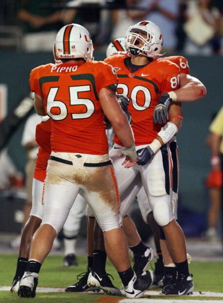 FORT LAUDERDALE, FL - SEPTEMBER 17: Tight end Jimmy Graham #80 of the Miami Hurricanes celebrates his touchdown catch with offensive linemen Matt Pipho #65 and Jason Fox #64 against the Georgia Tech Yellow Jackets at Land Shark Stadium on September 17, 2