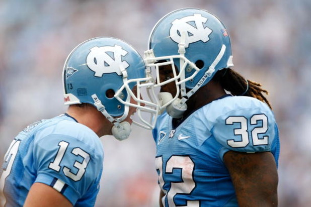 CHAPEL HILL, NC - SEPTEMBER 19:  Teammates T.J. Yates #13 and Ryan Houston #32 of the North Carolina Tar Heels celebrate after Houston's touchdown late in the fourth quarter against the East Carolina Pirates at Kenan Stadium on September 19, 2009 in Chape