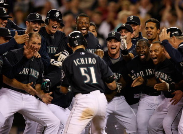 SEATTLE - SEPTEMBER 18:  Ichiro Suzuki #51 of the Seattle Mariners is mobbed by teammates after hitting a game winning two-run homer in the bottom of the ninth inning to defeat the New York Yankees 3-2 on September 18, 2009 at Safeco Field in Seattle, Was