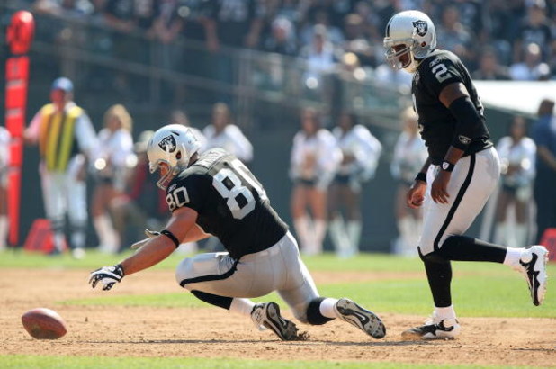 OAKLAND, CA - SEPTEMBER 27:  Zach Miller #80 of the Oakland Raiders recovers a fumble as JaMarcus Russell #2 looks on against the Denver Broncos on September 27, 2009 during an NFL game at the Oakland-Alameda County Coliseum in Oakland, California.  (Phot