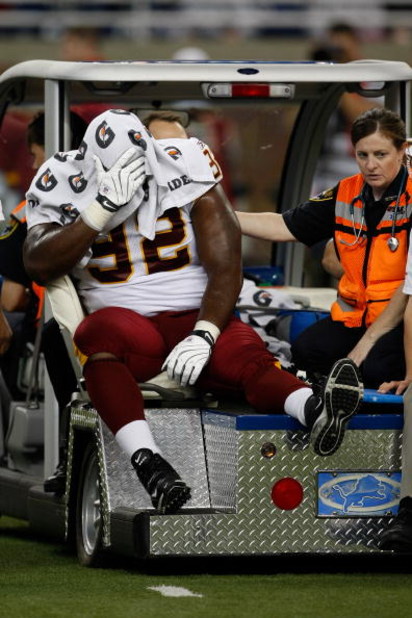 DETROIT, MI - SEPTEMBER 27: Defensive tackle Albert Haynesworth #92 of the Washington Redskins sits on a cart as he is taken off the field after an injury in the first half against the Detroit Lions at Ford Field on September 27, 2009 in Detroit, Michigan