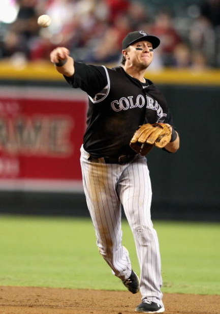 PHOENIX - SEPTEMBER 20:  Infielder Troy Tulowitzki #2 of the Colorado Rockies fields a ground ball out during the major league baseball game against the Arizona Diamondbacks at Chase Field on September 20, 2009 in Phoenix, Arizona. The Rockies defeated th