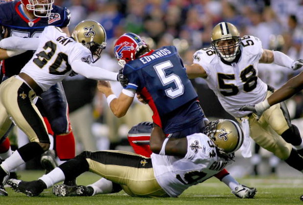 ORCHARD PARK, NY - SEPTEMBER 27: Randal Gay #24, Charles Grant #94 and Scott Shanlee #58  of the New Orleans Saints combine to sack Trent Edwards #5 of the Buffalo Bills  at Ralph Wilson Stadium on September 27, 2009 in Orchard Park, New York.  The Saints