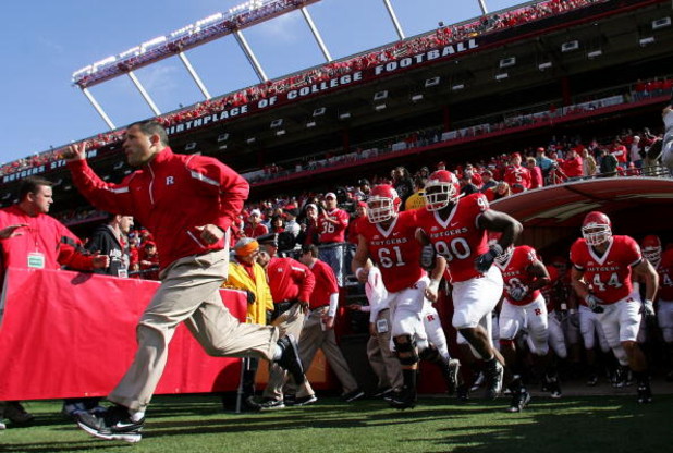 PISCATAWAY, NJ - OCTOBER 18:  Head coach Greg Schiano of the Rutgers Scarlet Knights leads his team onto the field to play the Connecticut Huskies at Rutgers Stadium on October 18, 2008 in Piscataway, New Jersey.  (Photo by Jim McIsaac/Getty Images)