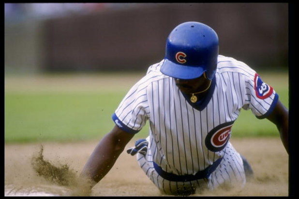 Jerome Walton of the Chicago Cubs slides into a base during a game.