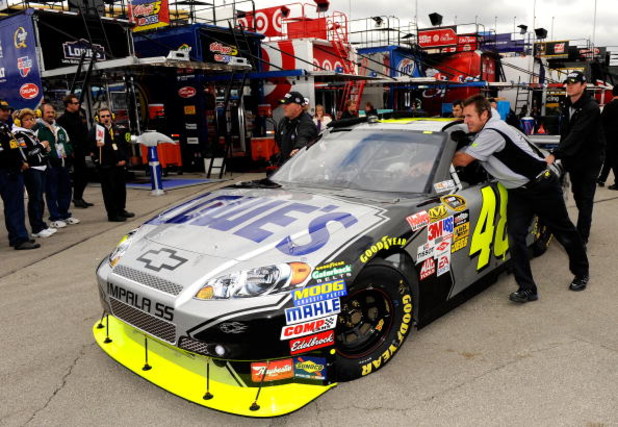 KANSAS CITY, KS - OCTOBER 03: The #48 Lowes Chevrolet driven by Jimmie Johnson is pushed through the garage area during practice for the NASCAR Sprint Cup Series Price Chopper 400 presented by Kraft Foods at the Kansas Speedway on October 3, 2009 in Kansa