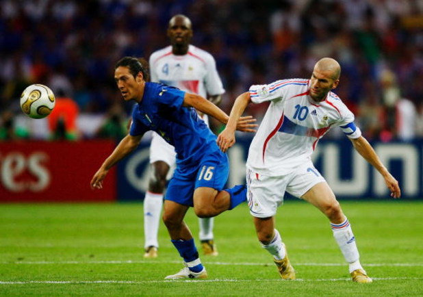 BERLIN - JULY 09:  Mauro Camoranesi of Italy (L) holds off Zinedine Zidane of France during the FIFA World Cup Germany 2006 Final match between Italy and France at the Olympic Stadium on July 9, 2006 in Berlin, Germany.  (Photo by Shaun Botterill/Getty Im