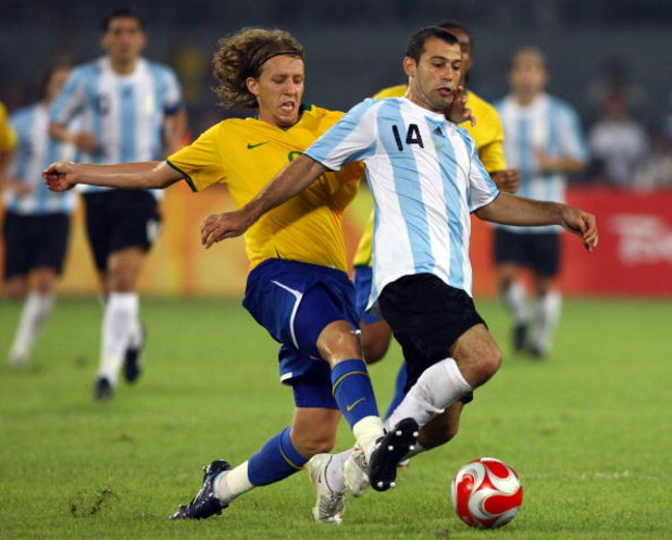BEIJING - AUGUST 19:  Javier Mascherano of Argentina is tackled by Lucas of Brazil during the men's football semifinal match at Workers' Stadium on Day 11 of the Beijing 2008 Olympic Games on August 19, 2008 in Beijing, China.  (Photo by Shaun Botterill/G