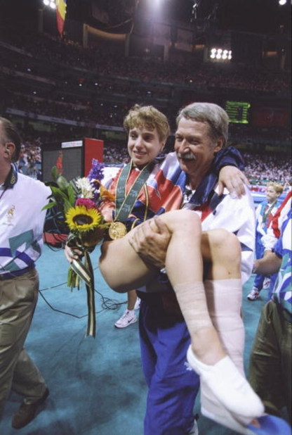 23 Jul 1996:  Bela Karolyi carries Kerri Strug off the floor during the Olympic Games at the Georgia Dome in Atlanta, Georgia. Mandatory Credit: Mike Powell  /Allsport