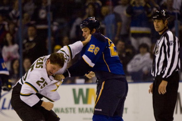 ST. LOUIS, MO. - SEPTEMBER 19: Warren Peters #25 of the Dallas Stars fights B.J. Crombeen #26 of the St. Louis Blues during a preseason game at the Scottrade Center on September 19, 2009 in St. Louis, Missouri.  (Photo by Dilip Vishwanat/Getty Images)
