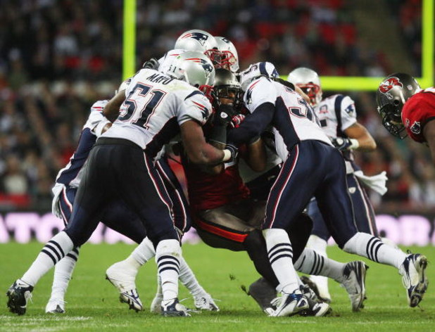 LONDON, ENGLAND - OCTOBER 25: Kellen Winslow (#82)of Tampa Bay Buccaneers is tackled by the New England Patriots defence during the NFL International Series match between New England Patriots and Tampa Bay Buccaneers at Wembley Stadium on October 25, 200