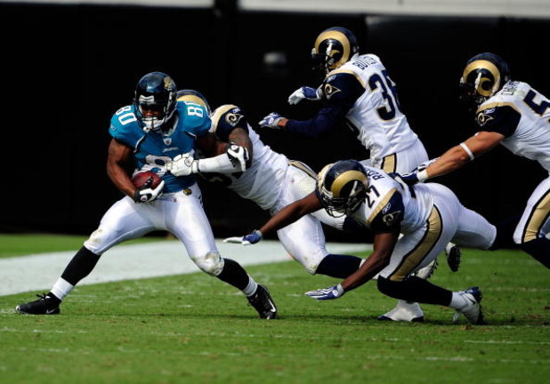 JACKSONVILLE, FL - OCTOBER 18: Mike Thomas #80 of the Jacksonville Jaguars is tackled by Quincy Butler #36 of the St. Louis Rams during the game at Jacksonville Municipal Stadium on October 18, 2009 in Jacksonville, Florida. (Photo by Sam Greenwood/Gett