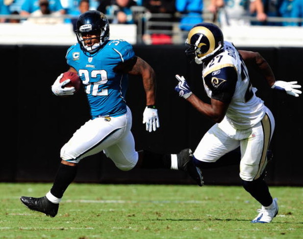 JACKSONVILLE, FL - OCTOBER 18: Maurice Jones-Drew #32 of the Jacksonville Jaguars is chased by David Roach #27 of the St. Louis Rams during the game at Jacksonville Municipal Stadium on October 18, 2009 in Jacksonville, Florida. (Photo by Sam Greenwood/