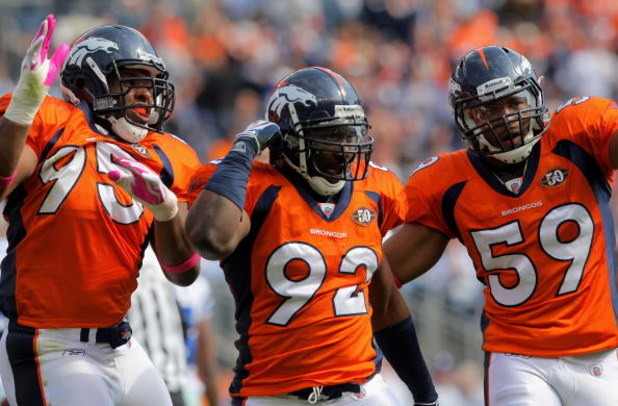DENVER - OCTOBER 04: Elivs Dumervil #92 of the Denver Broncos celebrates his sack of quarterback Tony Romo #9 of the Dallas Cowboys with teammates Darrell Reid #95 and Wesley Woodyard #59 during NFL action at Invesco Field at Mile High on October 4, 2009