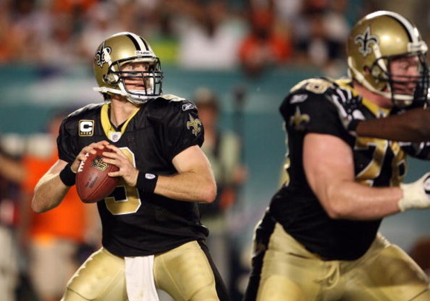 MIAMI - OCTOBER 25: Quarterback Drew Brees #9 of the New Orleans Saints drops back to pass against the Miami Dolphins at Land Shark Stadium on October 25, 2009 in Miami, Florida. The Saints defeated the Dolphins 46-34. (Photo by Doug Benc/Getty Images)