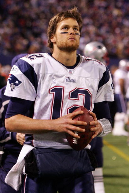 EAST RUTHERFORD, NJ - DECEMBER 29:  Tom Brady #12 of the New England Patriots looks on from the sidelines against the New York Giants on December 29, 2007 at Giants Stadium in East Rutherford, New Jersey.  (Photo by Jim McIsaac/Getty Images)