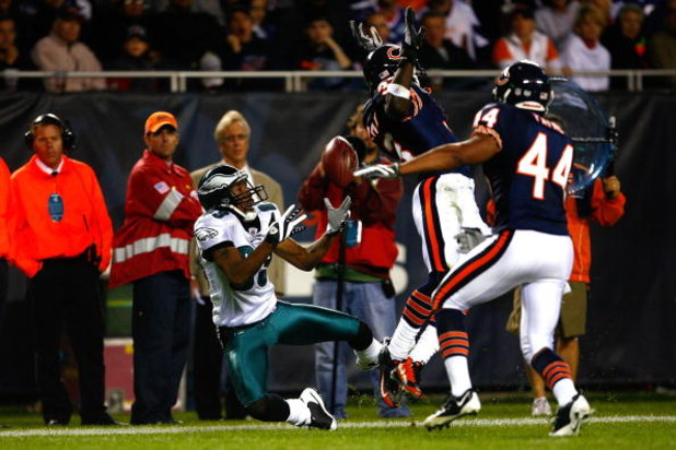 CHICAGO - SEPTEMBER 28:  Greg Lewis #83 of the Philadelphia Eagles attempts to make a catch against Charles Tillman #33 and Kevin Payne #44 of the Chicago Bears at Soldier Field on September 28, 2008 in Chicago, Illinois. The Bears won 24-20. (Photo by Je