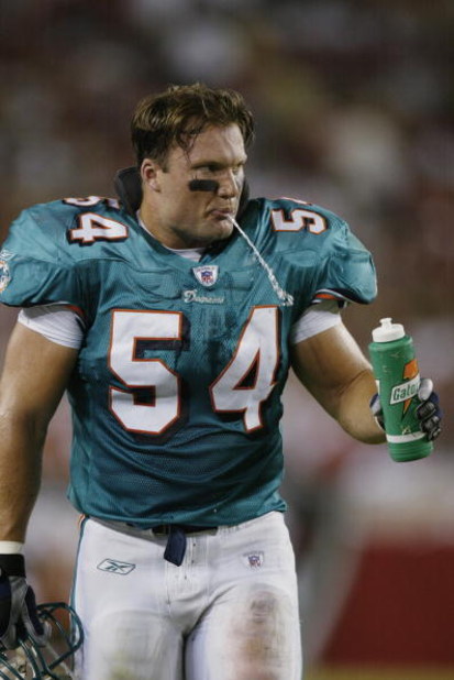TAMPA, FL - AUGUST 12:  Linebacker Zach Thomas #54 of the Miami Dolphins spits water on the field against the Tampa Bay Buccaneers on August 12, 2002 at Raymond James Stadium in Tampa, Florida.  The Buccaneers defeated the Dolphins 14-10.  (Photo By Eliot