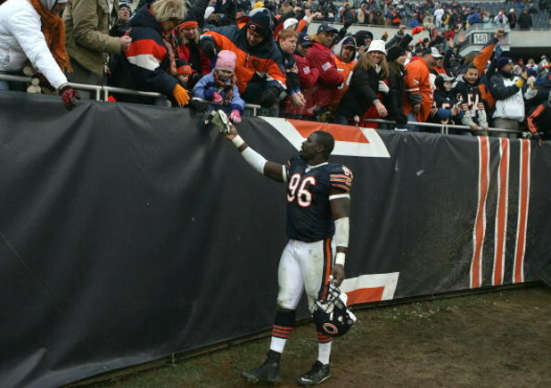 CHICAGO - DECEMBER 30:  Alex Brown #96 of the Chicago Bears gives his gloves to a young fan after the Bears 33-25 win against the New Orleans Saints at Soldier Field on December 30, 2007 in Chicago, Illinois.  (Photo by Jonathan Daniel/Getty Images)