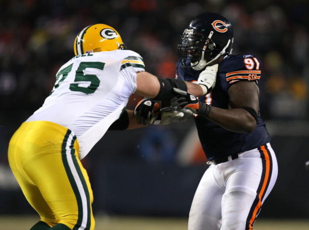 CHICAGO - DECEMBER 22: Tony Moll #75 of the Green Bay Packers blocks Tommie Harris #91 of the Chicago Bears on December 22, 2008 at Soldier Field in Chicago, Illinois. The Bears defeated the Packers 20-17 in overtime. (Photo by Jonathan Daniel/Getty Image