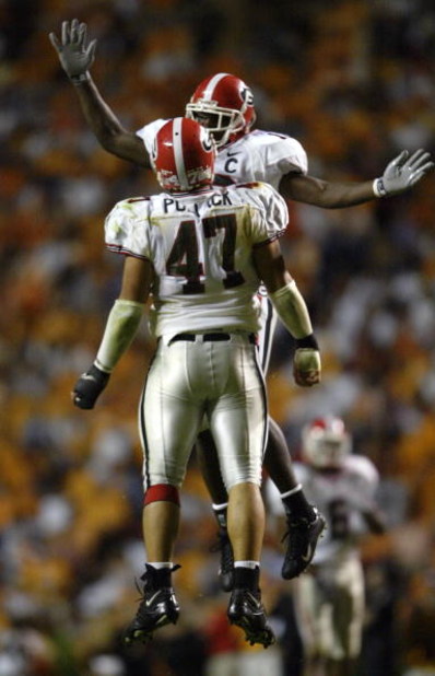 KNOXVILLE, TN - OCTOBER 11:  David Pollack #47 and Thomas Davis #10 of the Georgia Bulldogs celebrate a quarterback sack by Pollack in the second half against the Tennessee Volunteers on October 11, 2003 at Neyland Stadium in Knoxville, Tennessee. Georgia