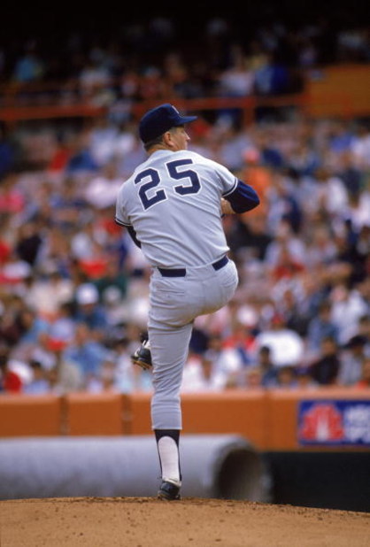 ANAHEIM, CA - 1989:  Tommy John #25 of the New York Yankees pitches during a 1989 season game against the California Angels at Anaheim Stadium in Anaheim, California.  (Photo by Stephen Dunn/Getty Images)